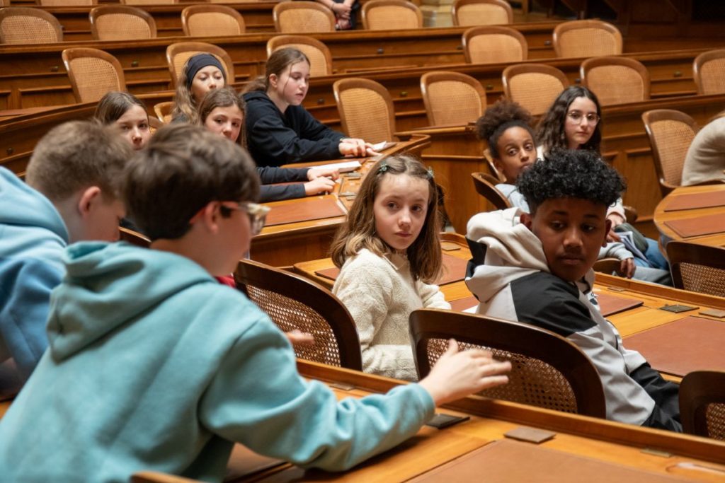 Photo des jeunes délégués dans un espace emblématique du Palais fédéral.